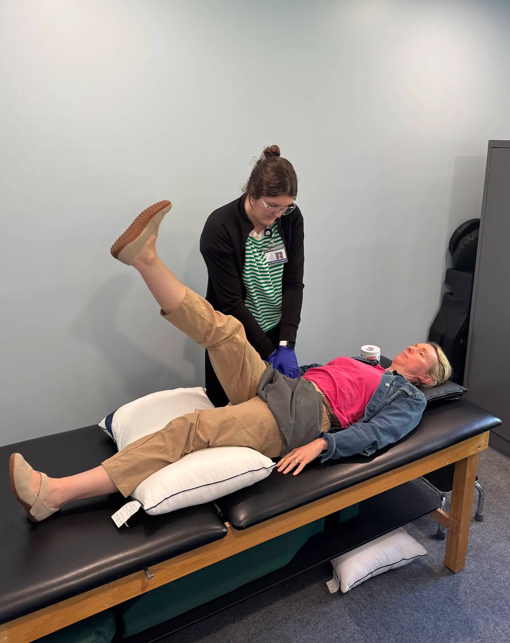 A Beyond Physical Therapy clinician providing one-on-one treatment in a private clinic room.
