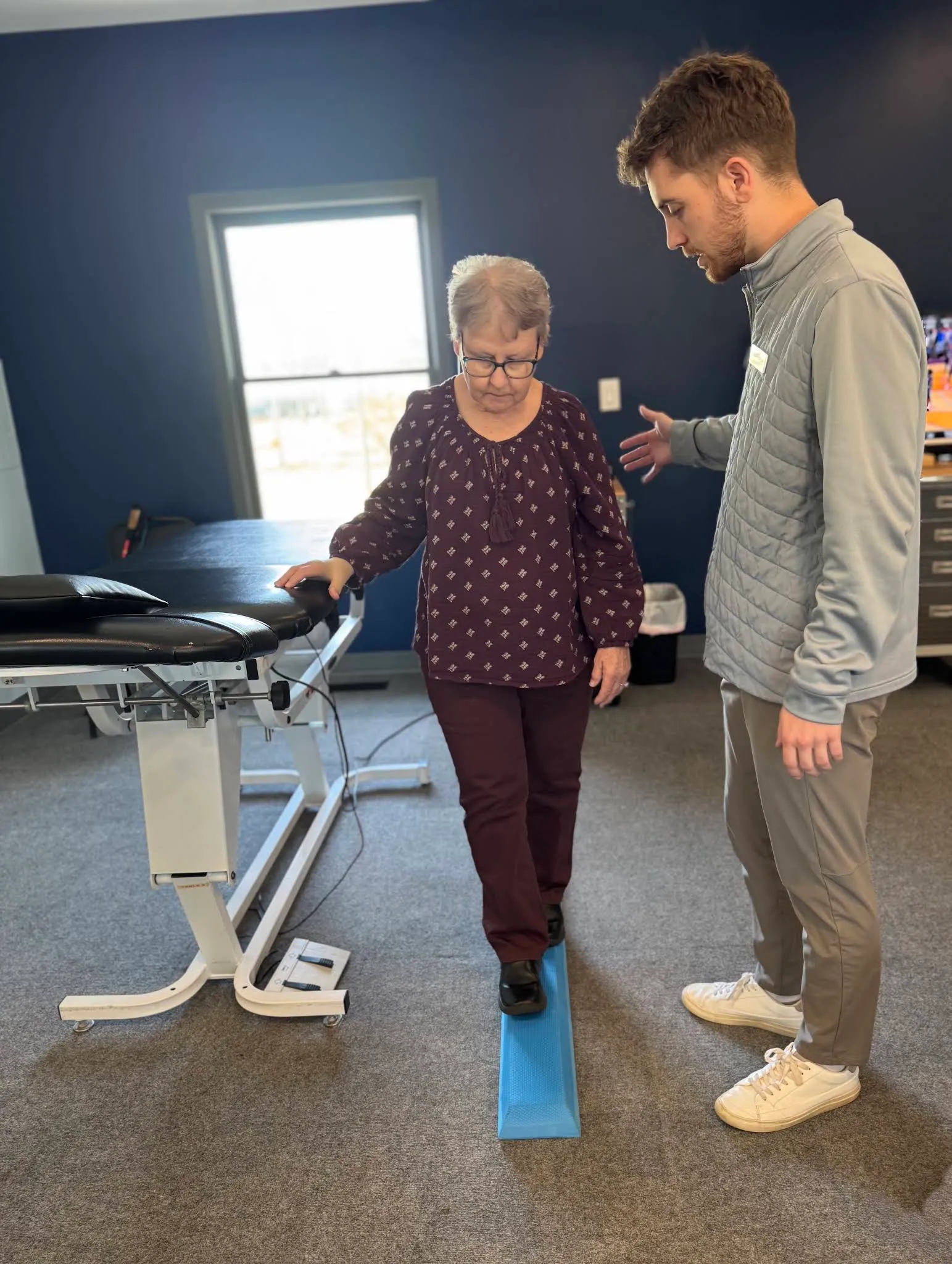 A Beyond Physical Therapy clinician helping a patient with balance training after surgery.