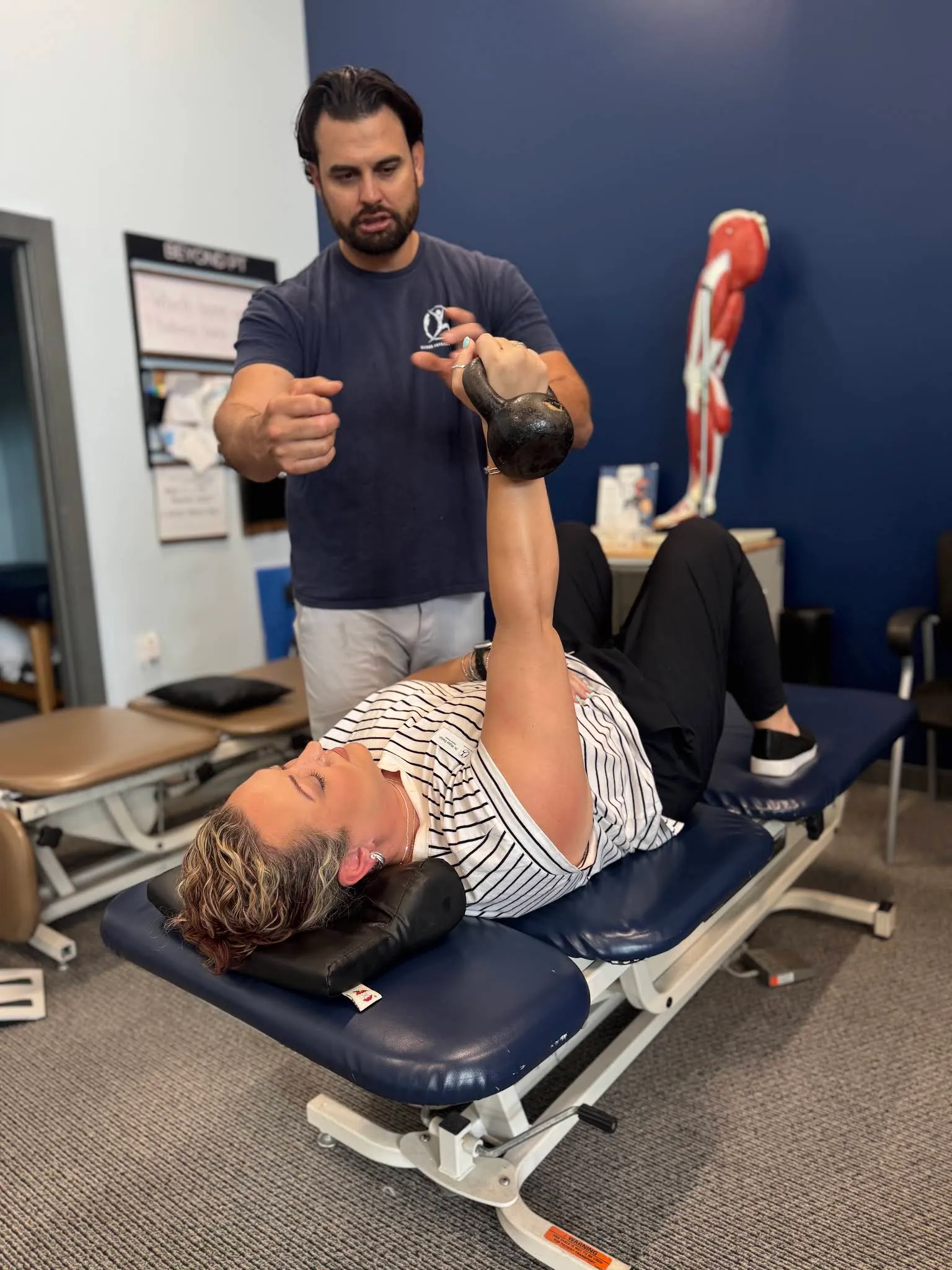 A Beyond Physical Therapy clinician guiding one-on-one recovery work in the Franklin clinic.